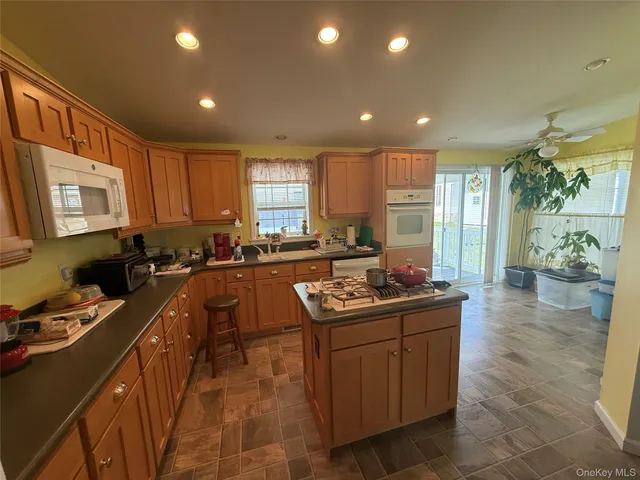 a kitchen that has a sink in it and wooden cabinets
