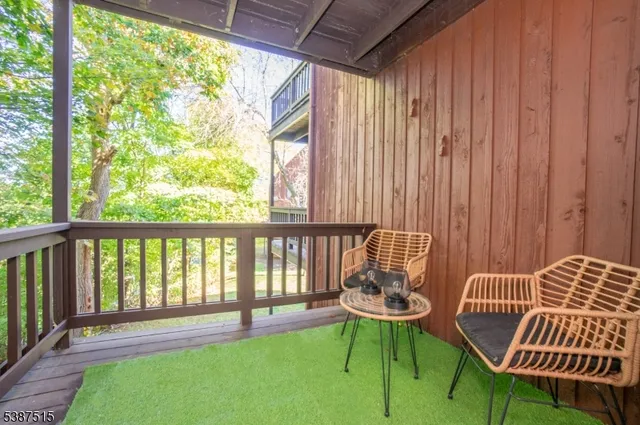 a balcony with chairs and a table