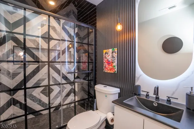 a bathroom with a toilet sink and mirror