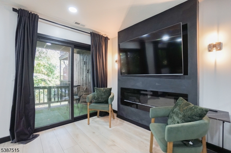 20 Augusta Drive, Unit 3 Vernon, NJ 07462 - Photo 6 of 11 a living room with furniture and a flat screen tv