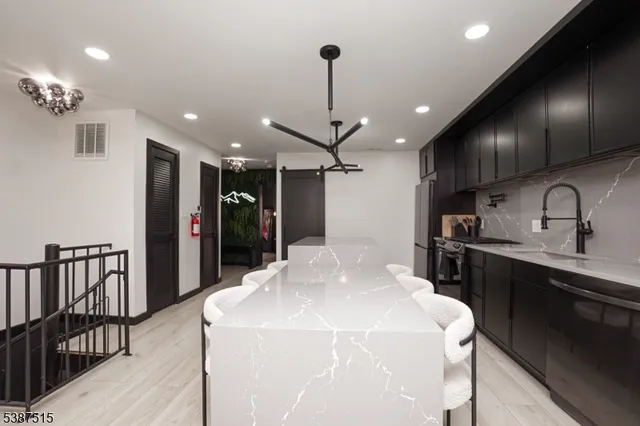 a kitchen with stainless steel appliances kitchen island granite countertop a sink and cabinets