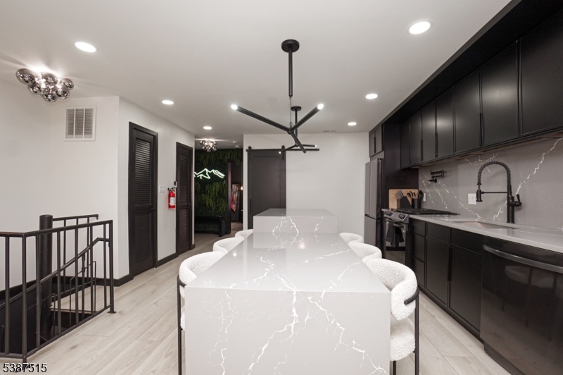 20 Augusta Drive, Unit 3 Vernon, NJ 07462 - Photo 7 of 11 a kitchen with stainless steel appliances kitchen island granite countertop a sink and cabinets