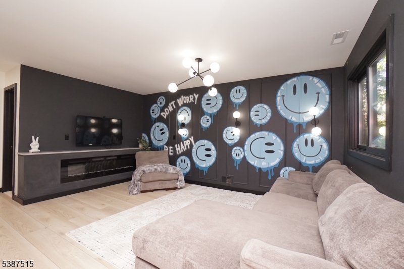 20 Augusta Drive, Unit 3 Vernon, NJ 07462 - Photo 8 of 11 a bedroom with a bed and a chandelier