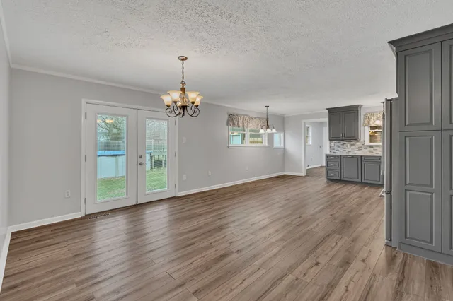 a view of a room with wooden floor staircase and windows