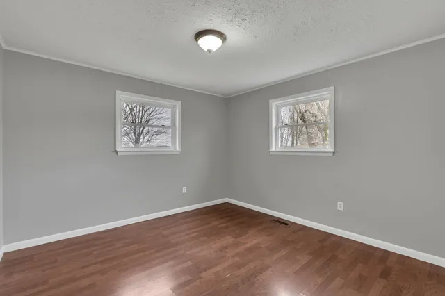 an empty room with wooden floor