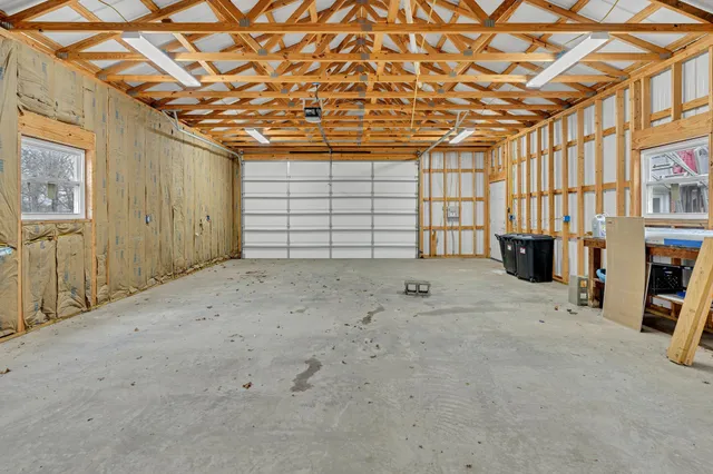 a front view of house with yard and trees in the background