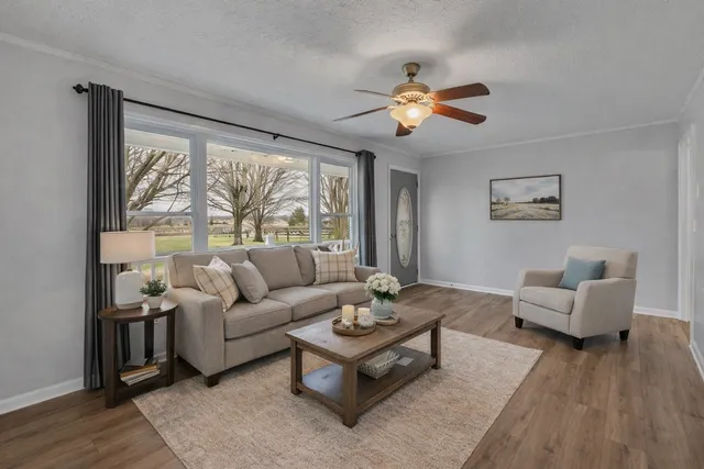 a living room with furniture and a large window