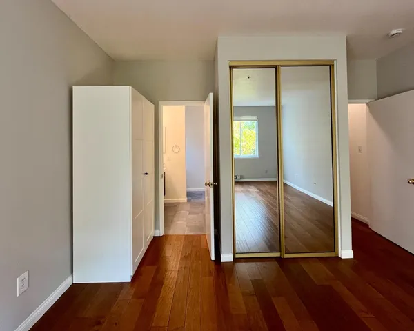 a view of a hallway with wooden floor