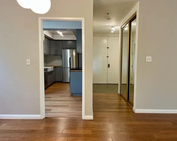 a view of a hallway with wooden floor