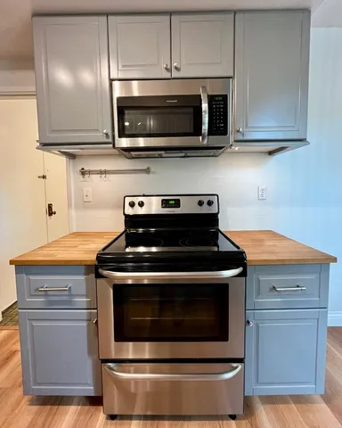 a stove top oven sitting inside of a kitchen and granite counter tops