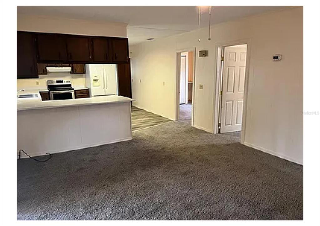 1657 Richland Avenue Deland, FL 32724 - Photo 2 of 5 a living room with stainless steel appliances kitchen island cabinets and a couch