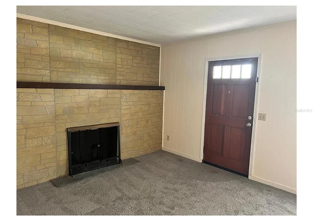 1657 Richland Avenue Deland, FL 32724 - Photo 4 of 5 a view of an empty room with window and fire place