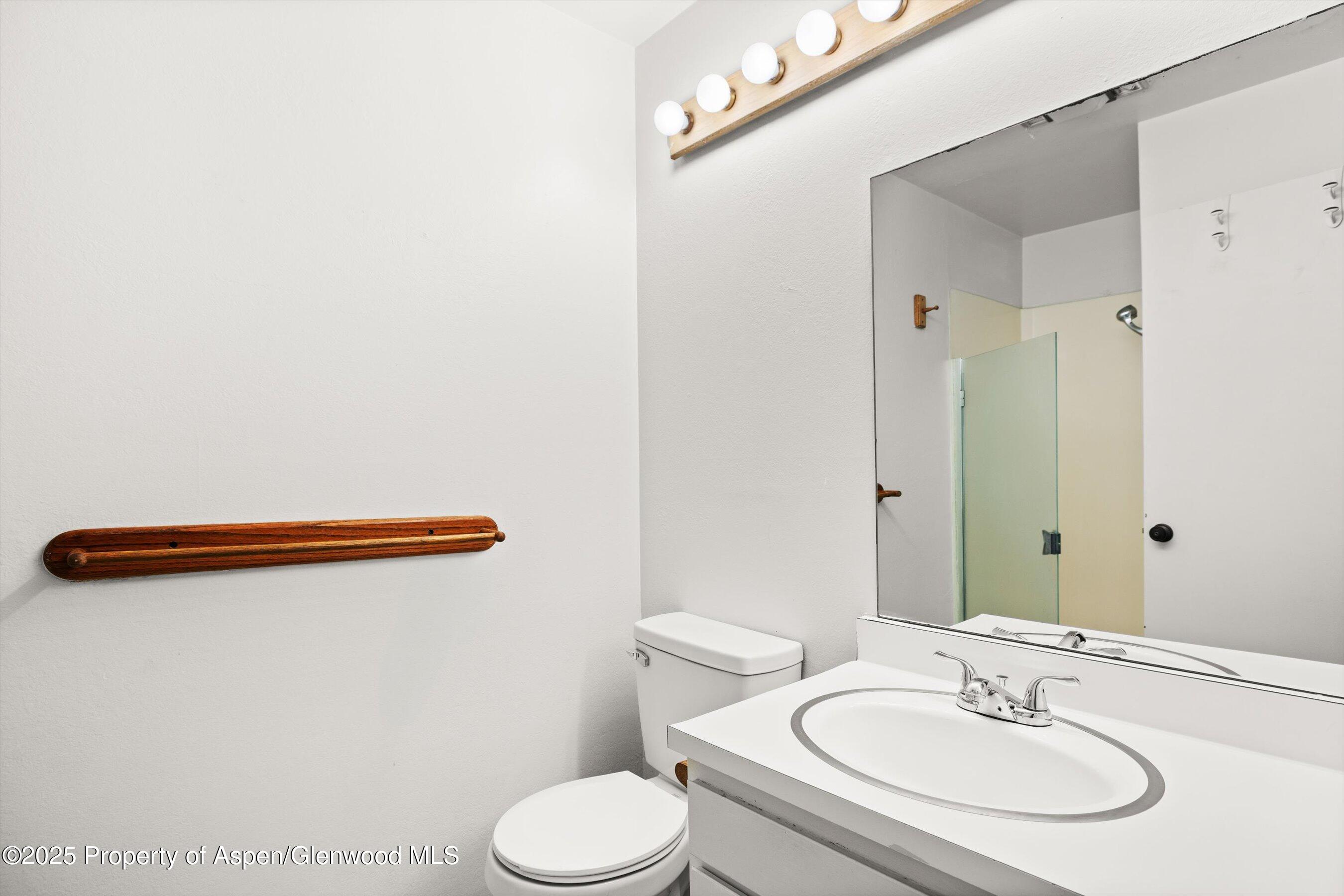 35 Lower Woodbridge Road, Unit V/177 Snowmass Village, CO 81615 - Photo 11 of 15 a bathroom with a sink a toilet a mirror and shower