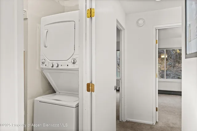 a close view of a utility room with dryer and washer