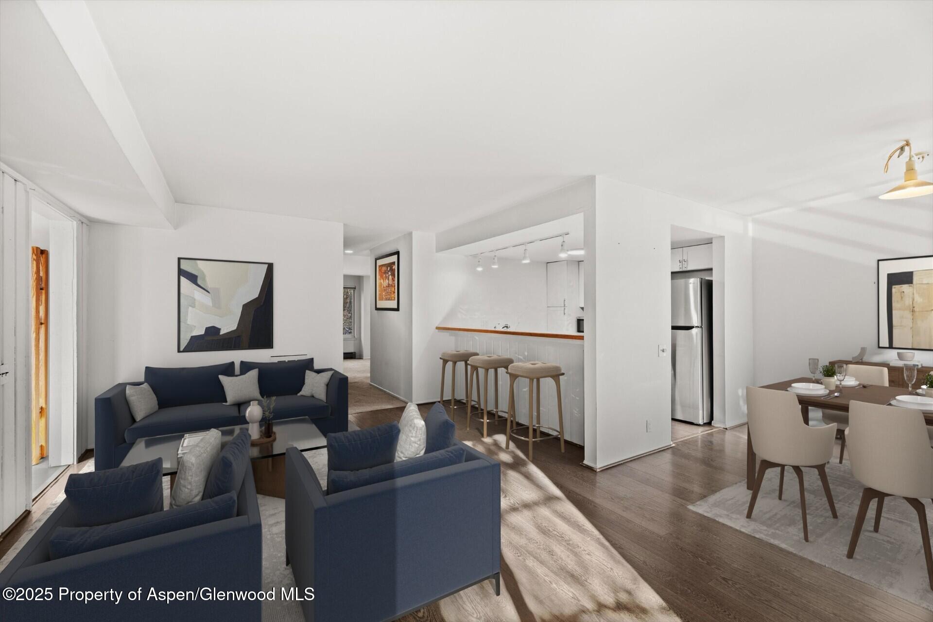 35 Lower Woodbridge Road, Unit V/177 Snowmass Village, CO 81615 - Photo 4 of 15 a living room with furniture and a wooden floor
