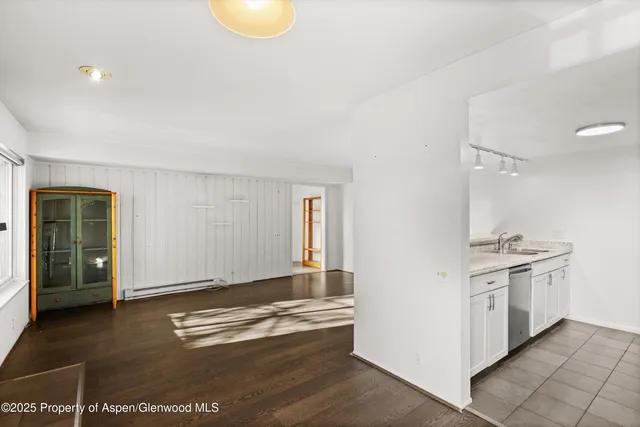 a view of kitchen with granite countertop cabinets and sink