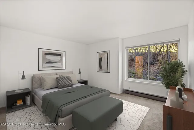 a bedroom with a large bed and a window with outer view