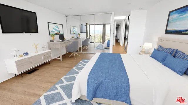 a bedroom with furniture and a flat screen tv