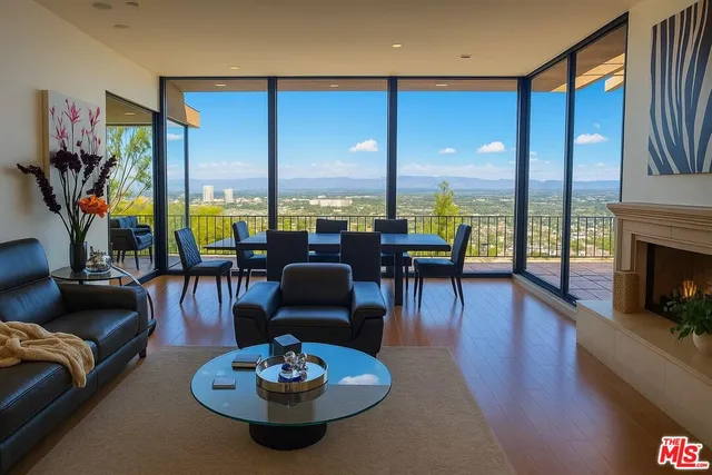 a view of a dining room with furniture one side kitchen view and a fireplace