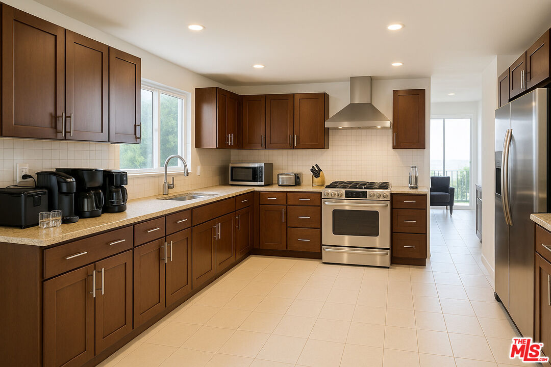 3873 Beverly Ridge Drive Sherman Oaks, CA 91423 - Photo 6 of 15 a large kitchen with stainless steel appliances granite countertop a stove a sink and a refrigerator