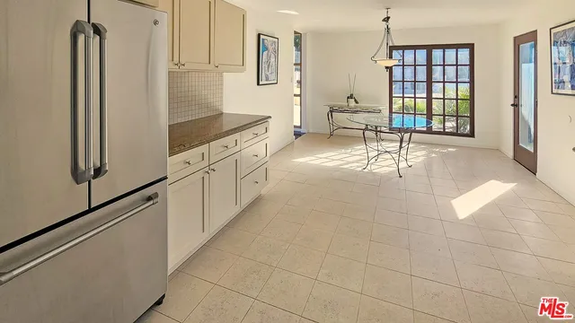 a spacious bedroom with a bed and a flat screen tv