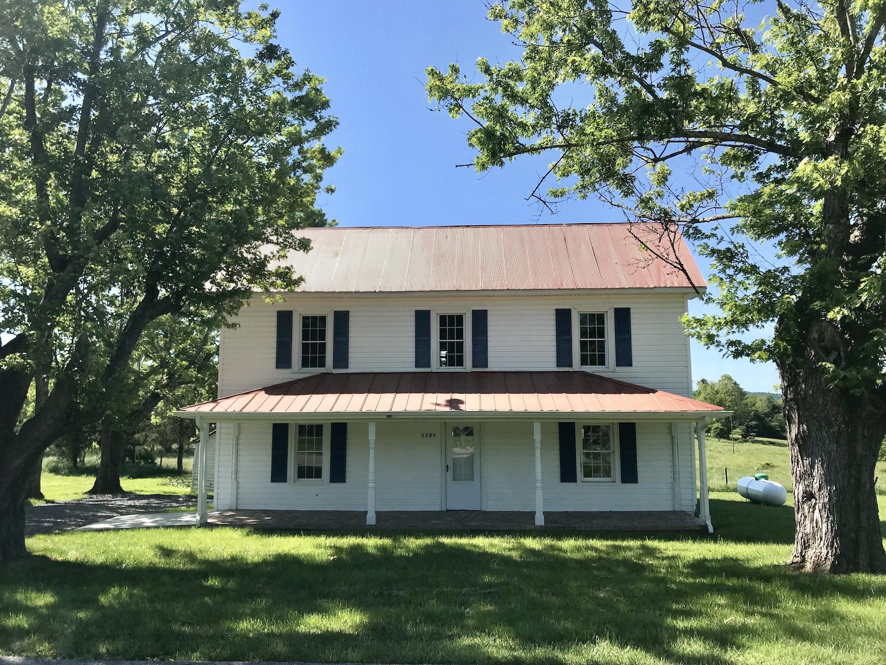 2503 Huffville Road Pilot, VA 24138 - Photo 1 of 26 a view of a white house with a big yard and large trees