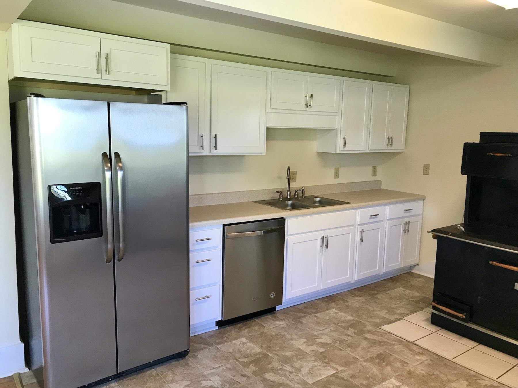 2503 Huffville Road Pilot, VA 24138 - Photo 13 of 26 a kitchen with a refrigerator sink and cabinets