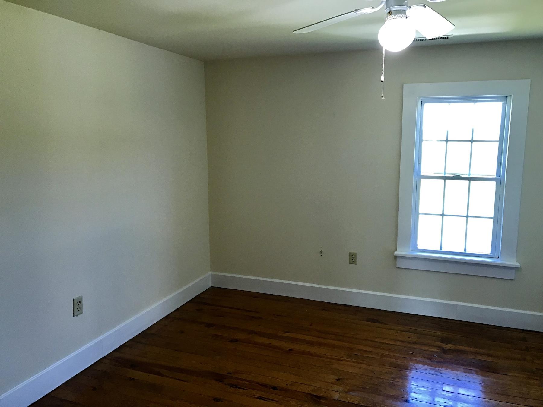 2503 Huffville Road Pilot, VA 24138 - Photo 19 of 26 an empty room with wooden floor and windows