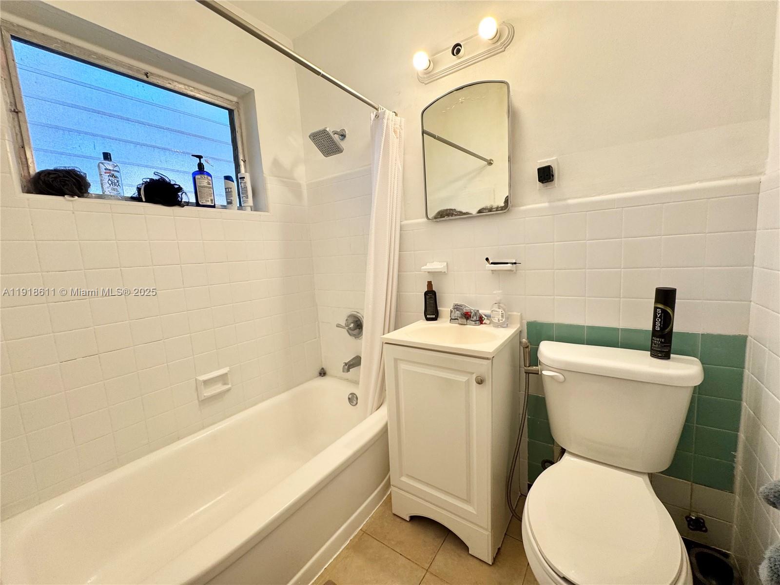 4740 Pine Tree Drive, Unit 32 Miami Beach, FL 33140 - Photo 11 of 20 a bathroom with a toilet sink and mirror