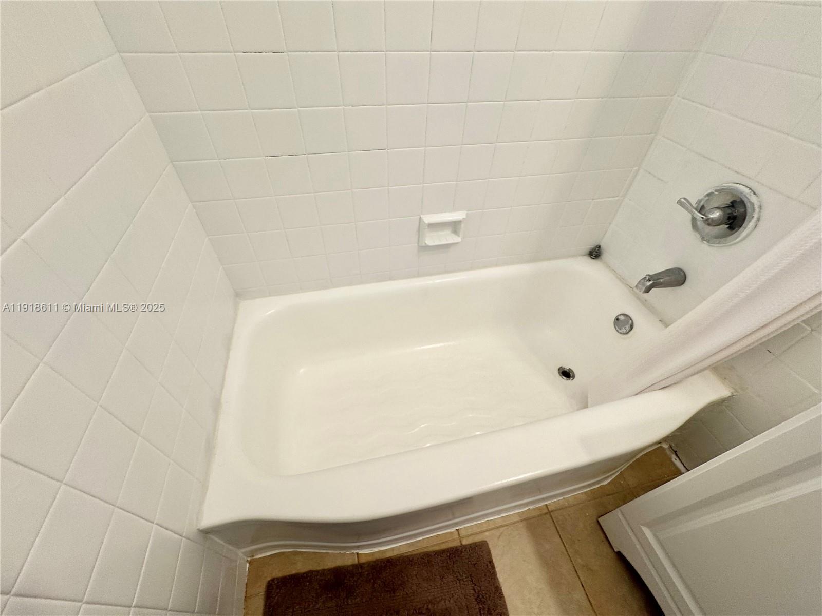 4740 Pine Tree Drive, Unit 32 Miami Beach, FL 33140 - Photo 12 of 20 a bathroom with a tub
