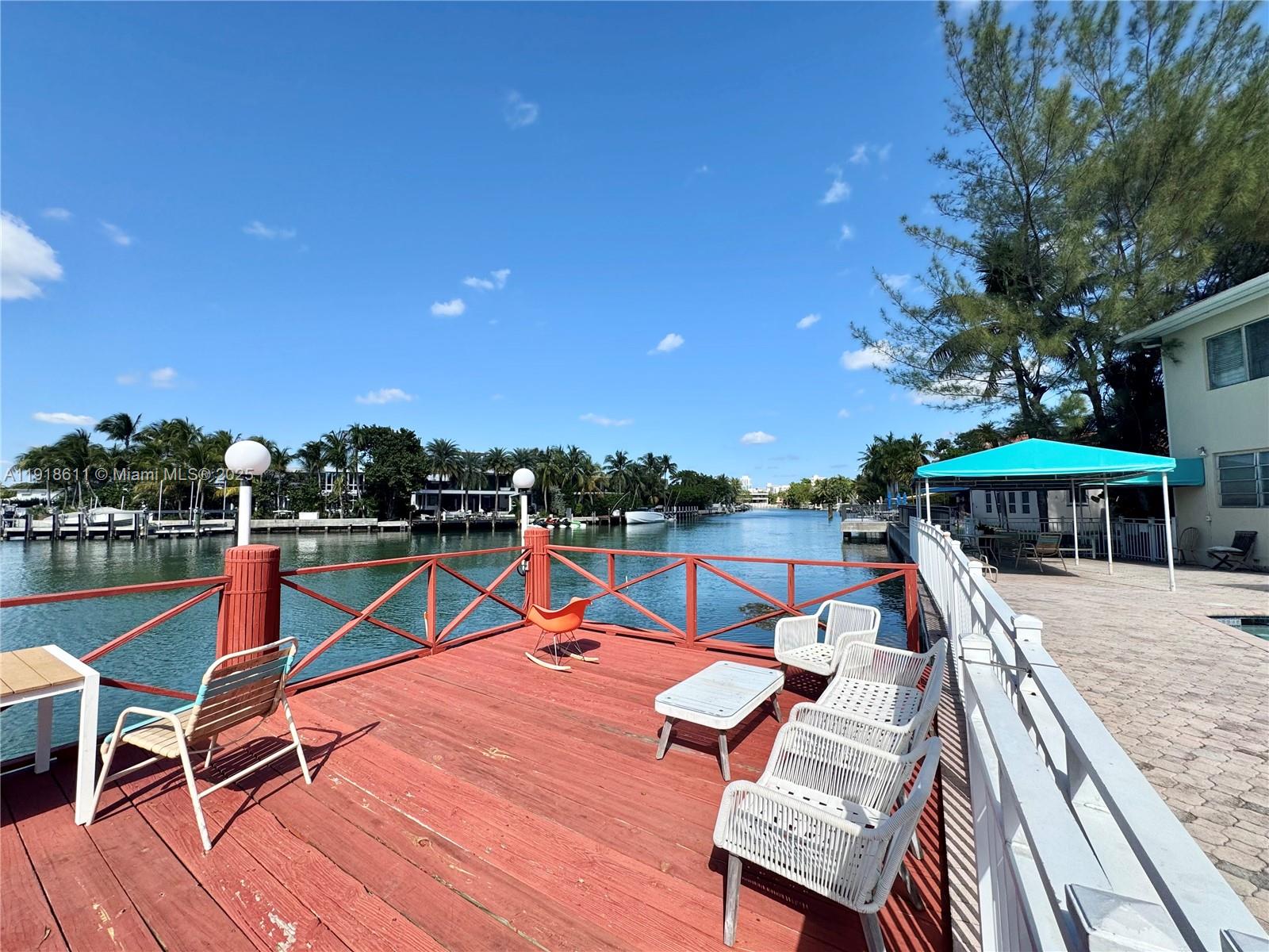 4740 Pine Tree Drive, Unit 32 Miami Beach, FL 33140 - Photo 4 of 20 a view of a patio with chairs and wooden floor