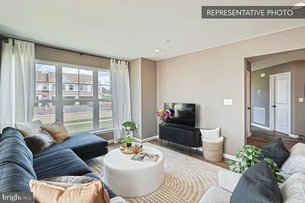 a living room with furniture and a large window