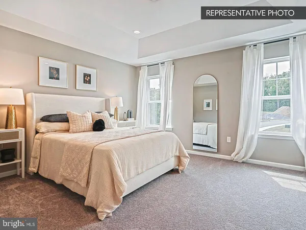 a spacious bedroom with a bed and a window