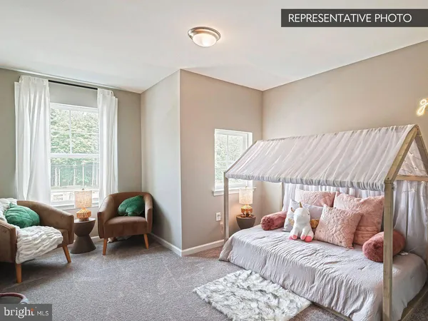 a bedroom with furniture and a window