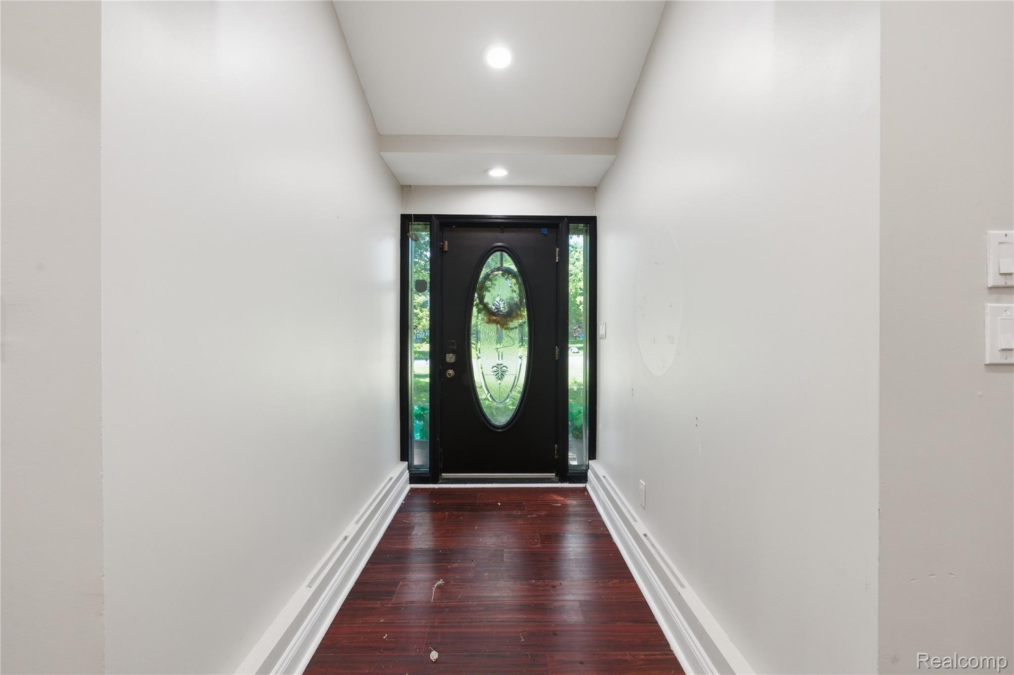 3812 Terrybrook Road West Bloomfield, MI 48322 - Photo 4 of 43 Entryway featuring rich wood-finish flooring, recessed lighting, and a dark-paneled door with an oval leaded glass insert