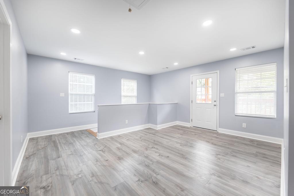 1909 Dannenberg Avenue Macon, GA 31201 - Photo 25 of 55 a view of an empty room with wooden floor and a window