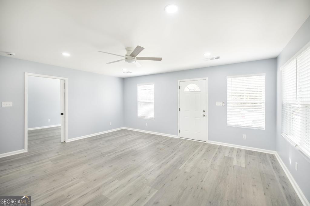 1909 Dannenberg Avenue Macon, GA 31201 - Photo 43 of 55 an empty room with wooden floor and windows