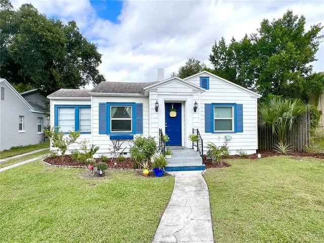 a front view of house with yard and green space