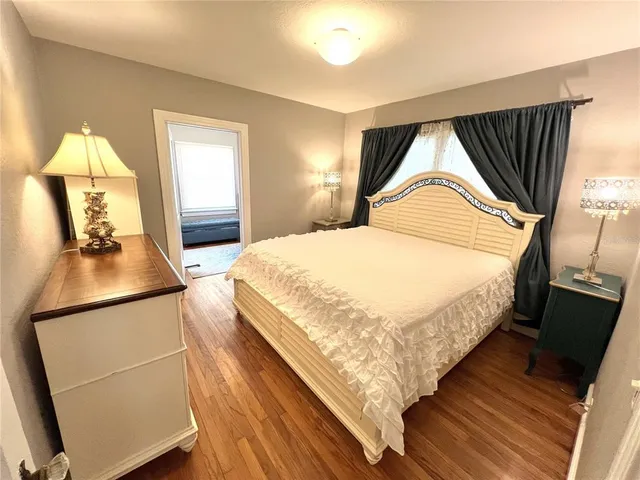 a bedroom with bed and window