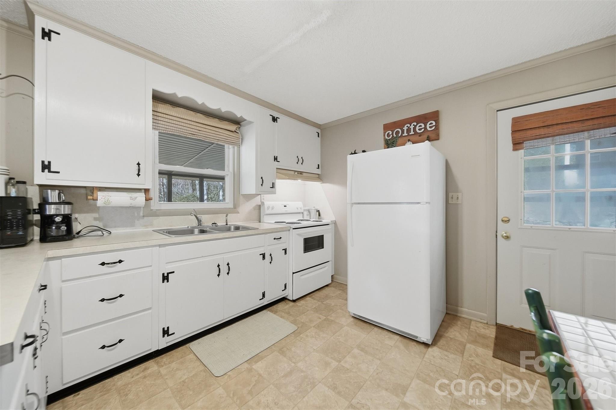 7218 Martin Road Newland, NC 28657 - Photo 11 of 27 a kitchen with sink cabinets and refrigerator