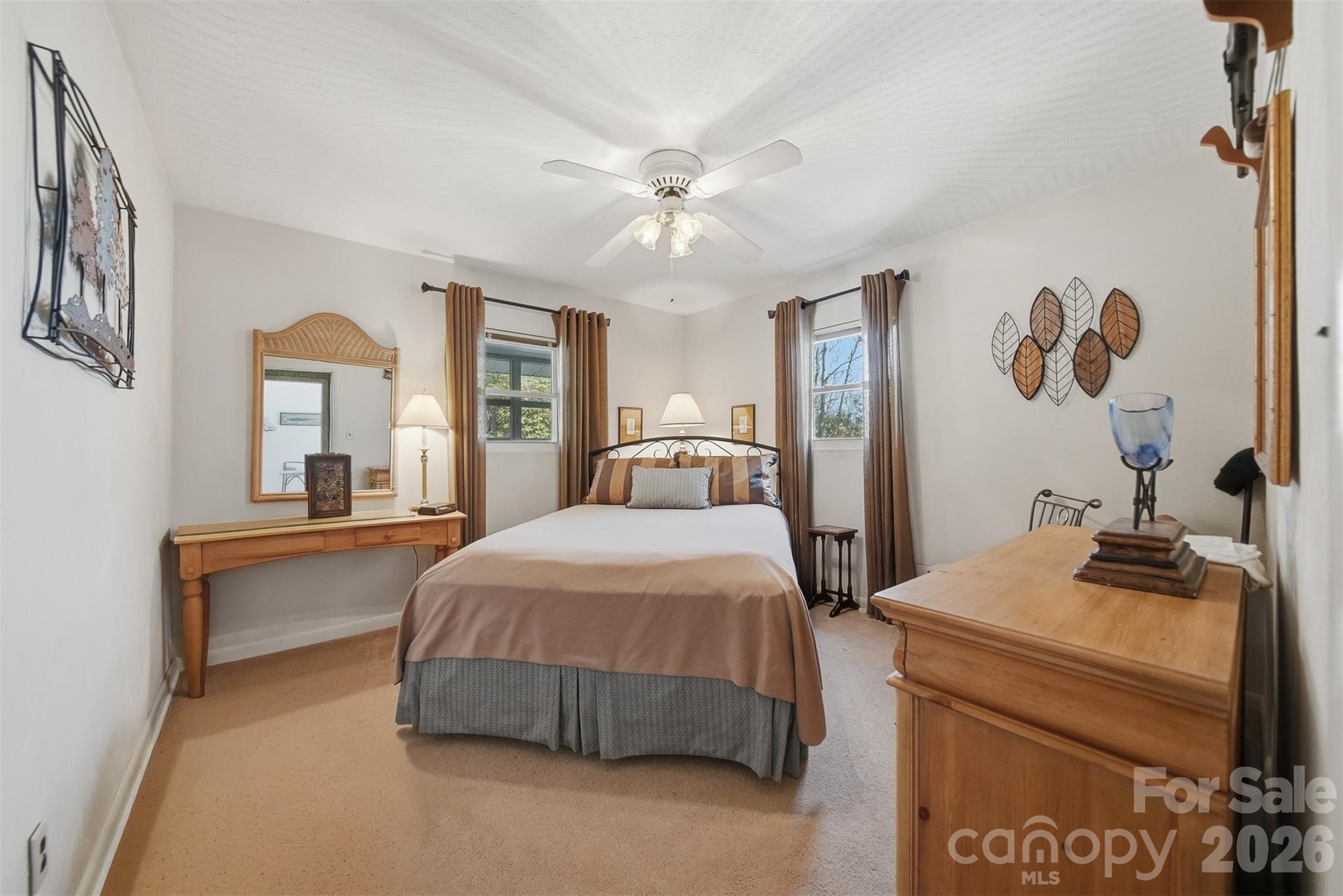 7218 Martin Road Newland, NC 28657 - Photo 16 of 27 a bedroom with a bed and a chandelier