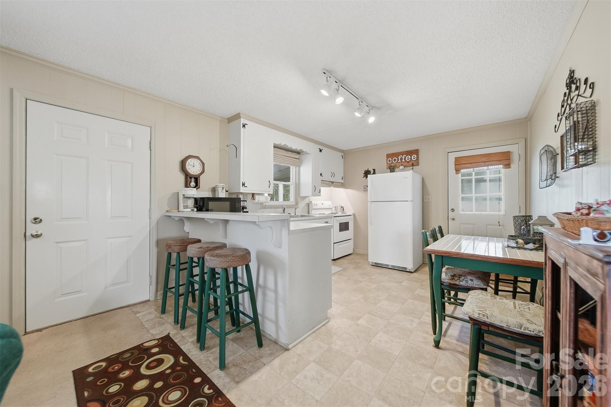 7218 Martin Road Newland, NC 28657 - Photo 10 of 27 a kitchen with white cabinets and stainless steel appliances