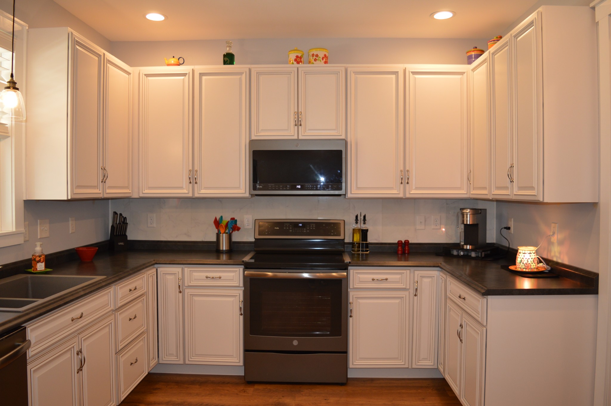 1387 Cooley's Rift Boulevard Monteagle, TN 37356 - Photo 12 of 24 a kitchen with stainless steel appliances granite countertop a stove a sink and white cabinets