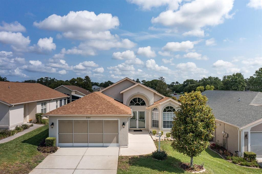 a front view of a house with a garden