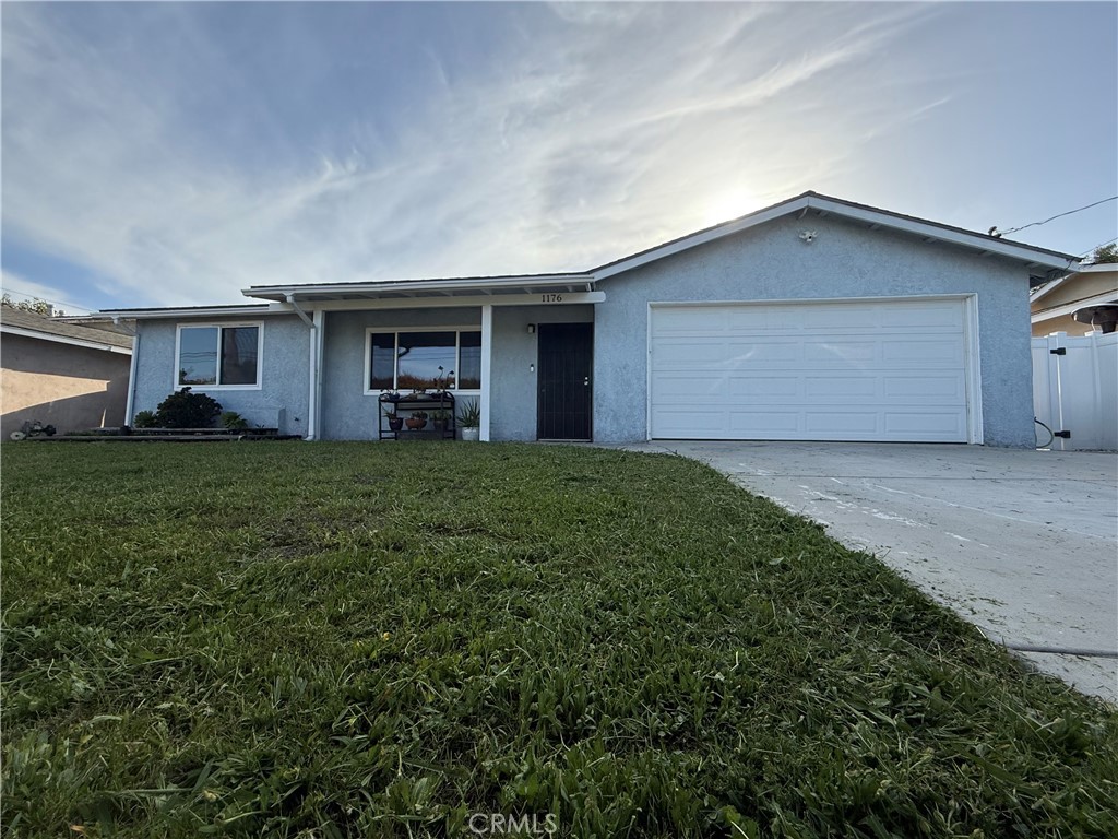 a view of a house with a yard and garage
