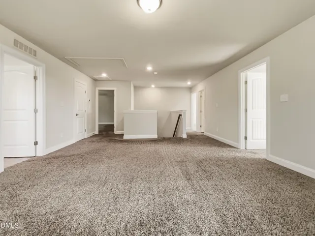 a view of a big room with refrigerator and windows