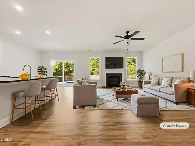 a living room with furniture a fireplace and a flat screen tv
