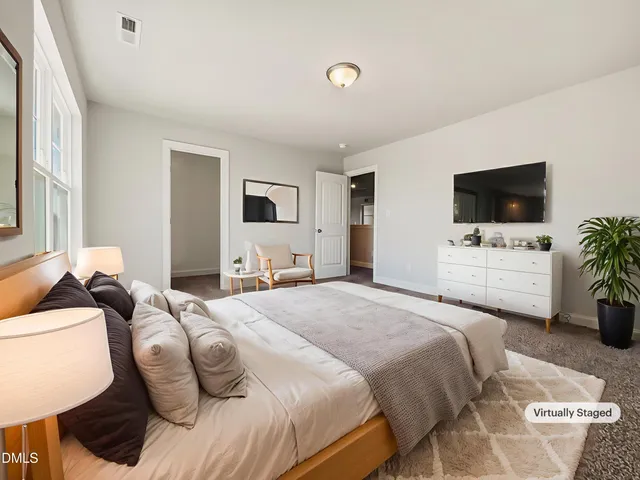 a bedroom with a bed and a flat screen tv