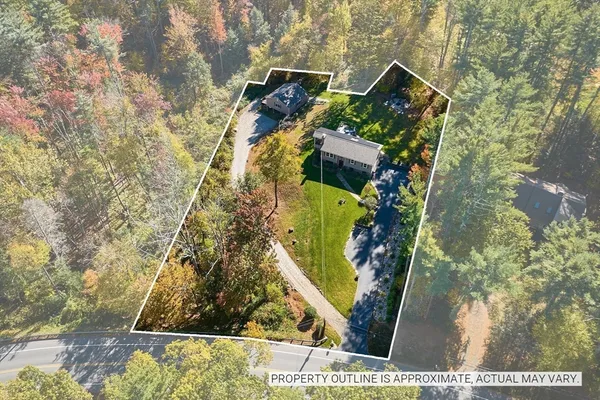 a kitchen with stainless steel appliances kitchen island granite countertop a stove a refrigerator a kitchen island a dining table and chairs with wooden floor