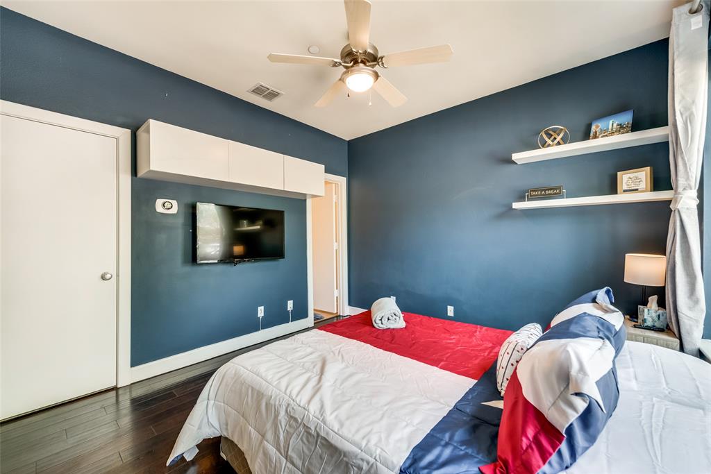 2718 Floyd Street Dallas, TX 75204 - Photo 11 of 25 a bedroom with a bed and a chandelier